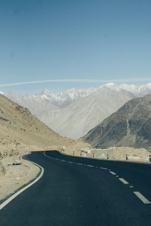 view of mountains, sand and blue skies in a clear sky