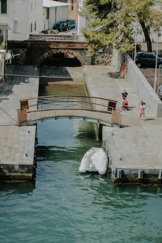 people are walking on the pier next to an iceberg