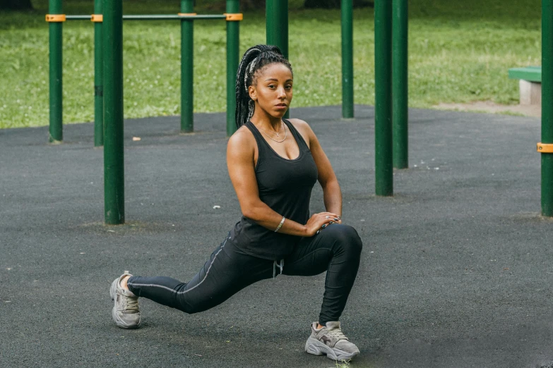 a woman doing stretching exercises in a park