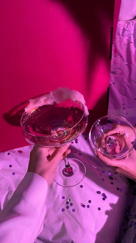 a close up of a person holding a wine glass