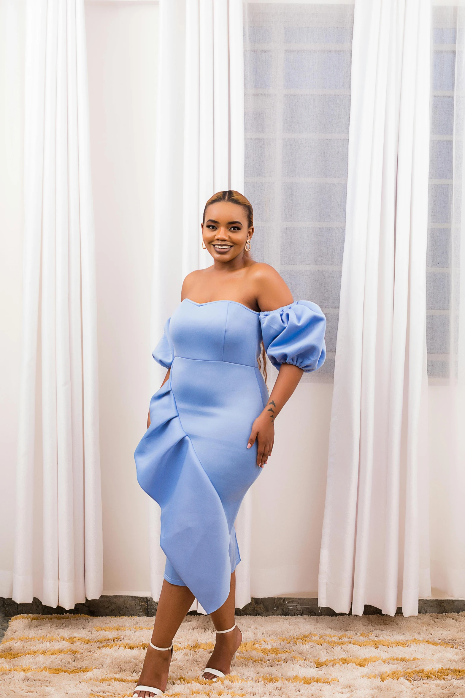 a woman wearing an off shoulder blue dress