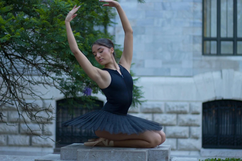 a young woman in a tutu is sitting on a bench