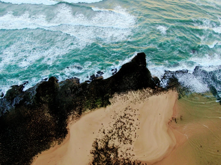 an aerial view of a sandy beach and ocean