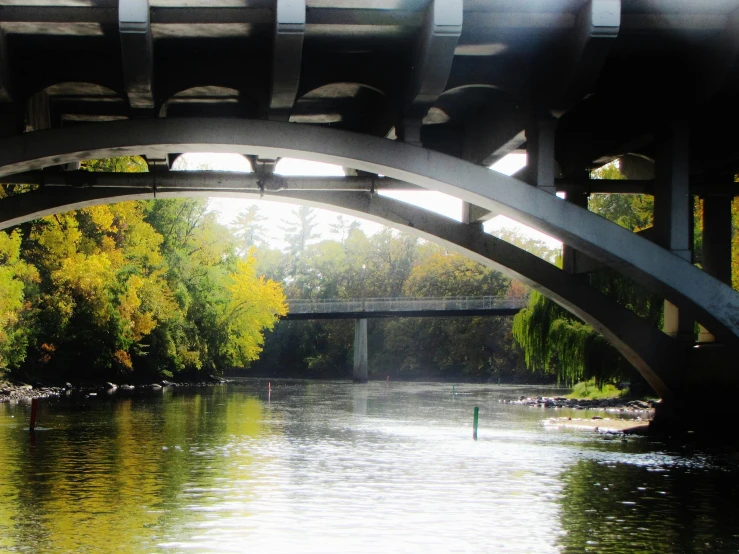 an outdoor bridge is seen next to a river