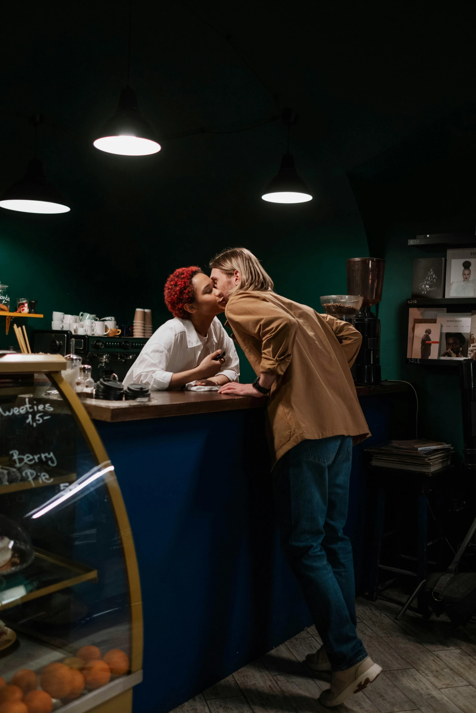 two people kissing each other in a bakery