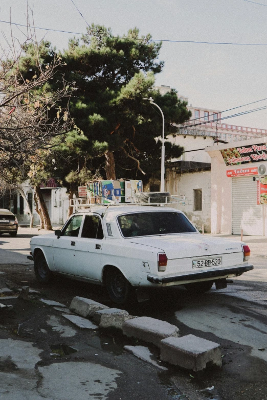 a white car parked on the side of a street