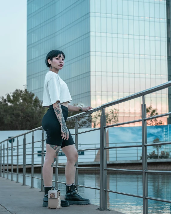 a woman in high heels is leaning against the rail