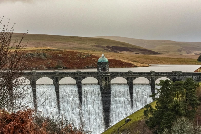 a large water dam with a bridge in the middle