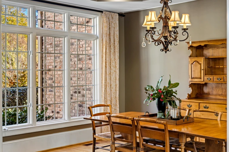 a dining room table that has a vase on it