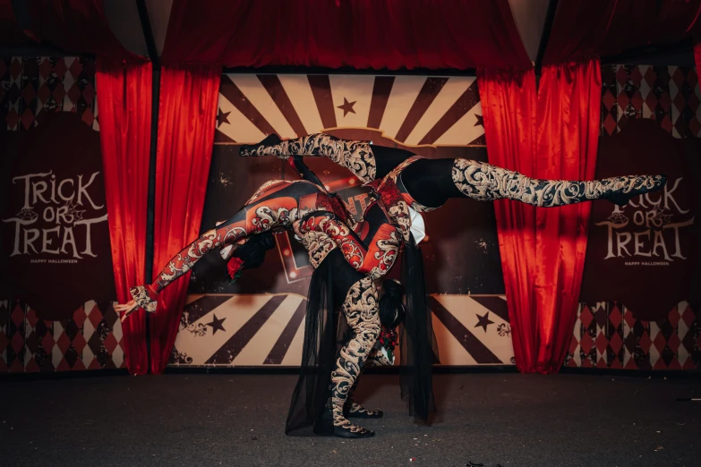 a woman dressed in costume doing acrobatic tricks