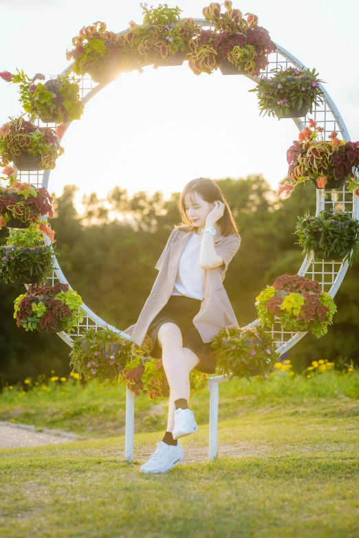 the girl is posed on a chair with flowers