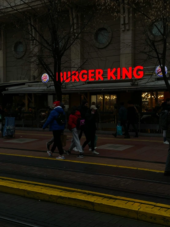 the people are walking together near the store