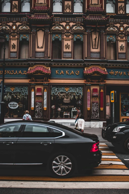 cars are parked in front of an ornate building