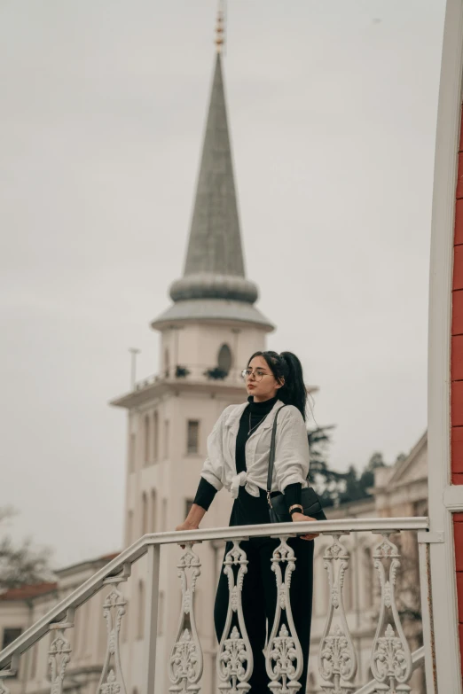 a woman standing on top of a hand rail