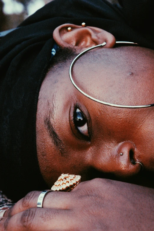 a black baby wearing a collar, ring, and choker with two small ears