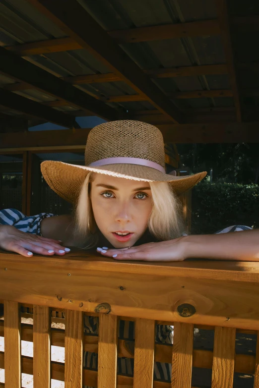 a woman with blonde hair and a straw hat