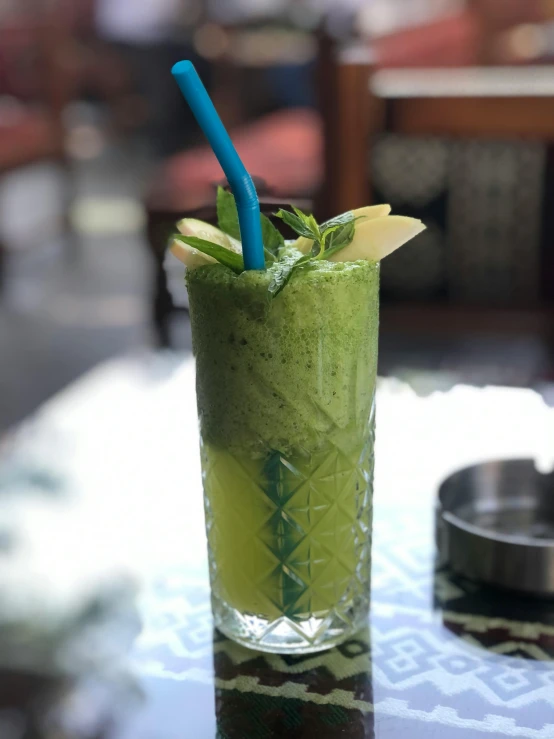 the tall cup on the table is filled with different types of drinks