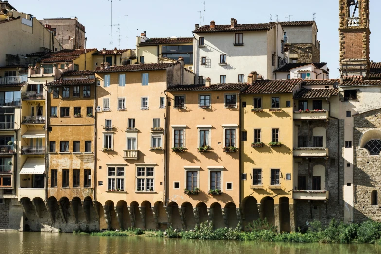 a group of buildings is sitting beside a body of water