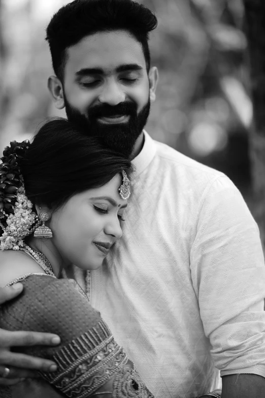 a man and woman cuddling in black and white