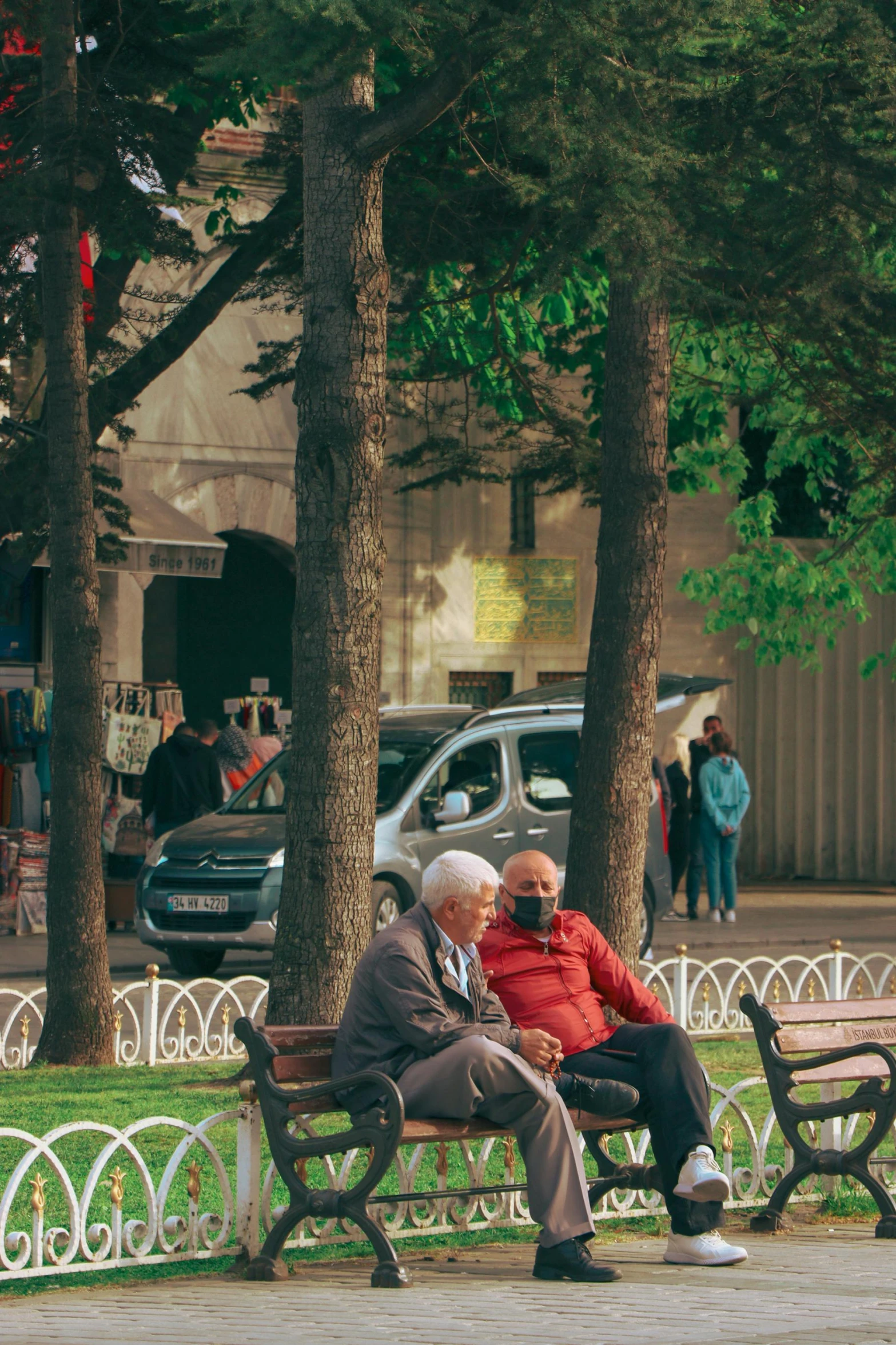 two elderly men sitting on a bench next to each other