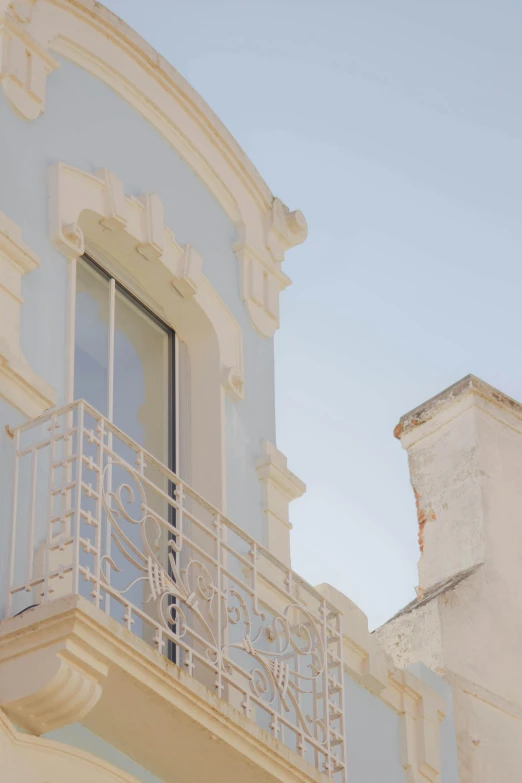 a window with white paint is open on the side of a building