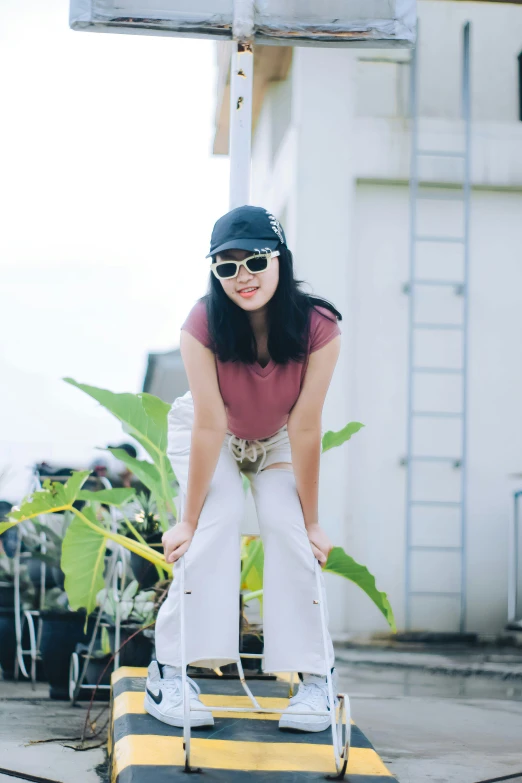 a woman stands on the yellow and white step