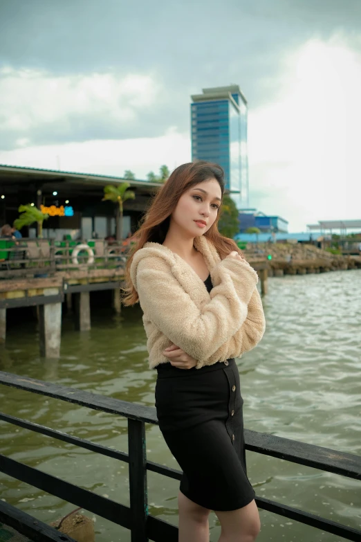 a woman standing on top of a dock by the water