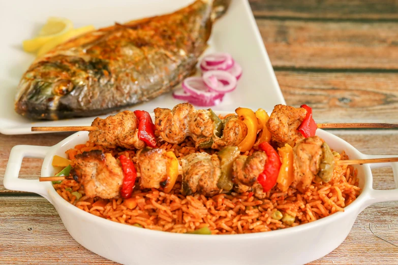 meat and vegetable skewers served on a bed of rice