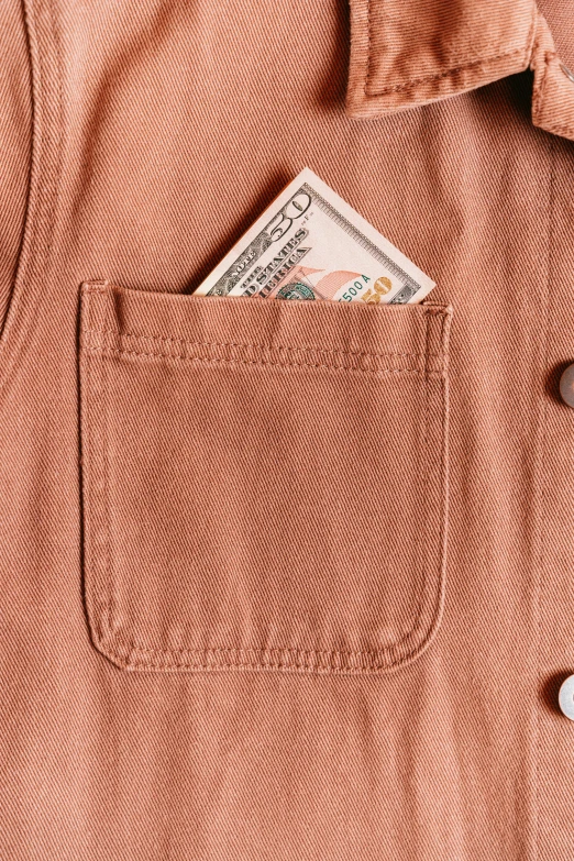 an orange on down shirt has a credit card in it