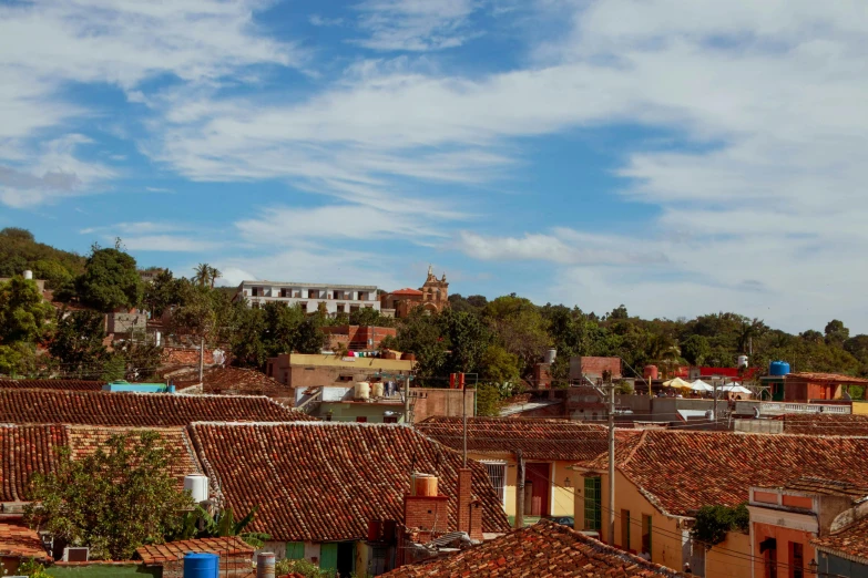 a city view with red roof tiles and some trees