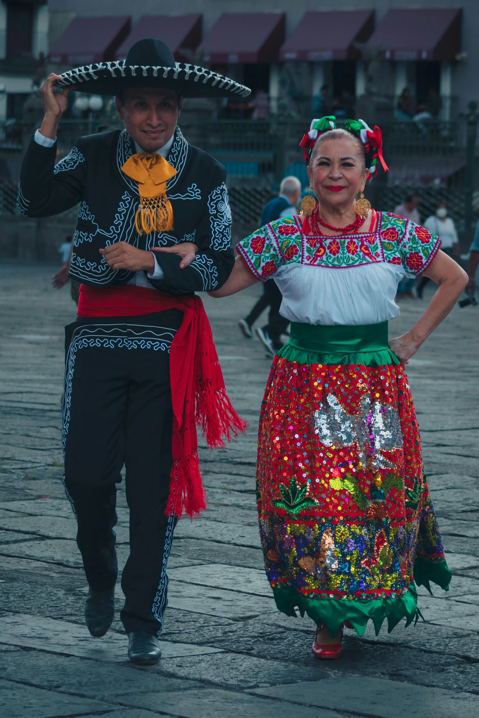 two people dressed in folk costumes for some sort of festival