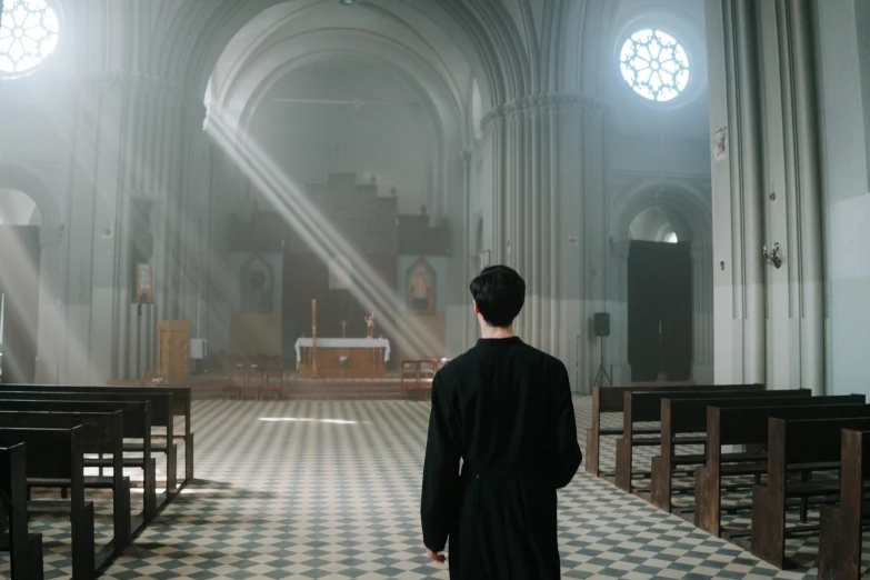 the priest is in a church during the day