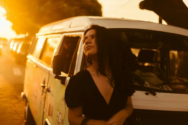 a woman is standing next to a van with a dog in the back window