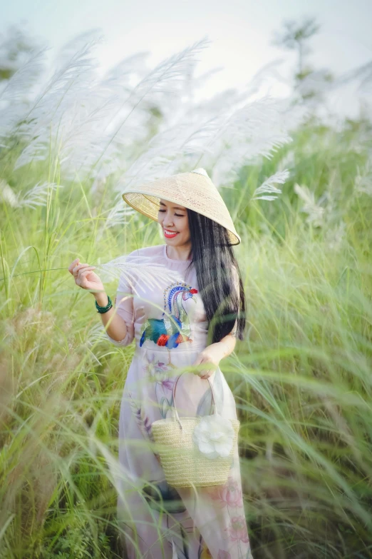 a woman is standing in some tall grass