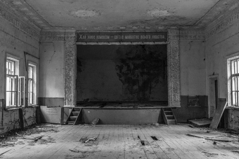 the empty hall of a historic building with the windows open