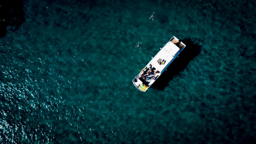 an aerial view of a small boat in the water