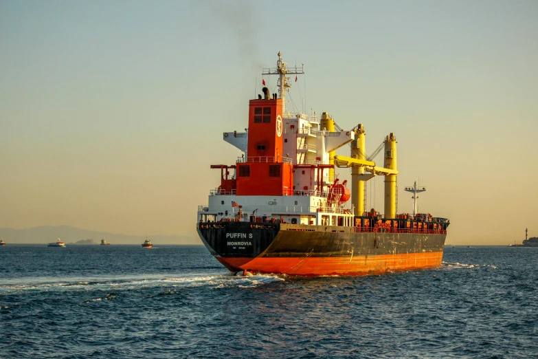 large cargo ship riding in the middle of the ocean