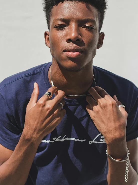 a man in a blue shirt putting on his ring