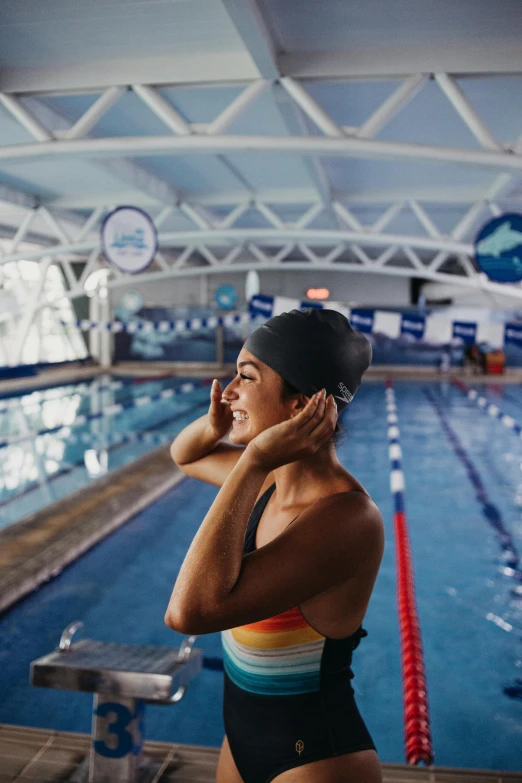 a woman in a swim suit is on her cell phone