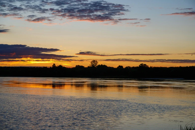 the reflection of the setting sun in water