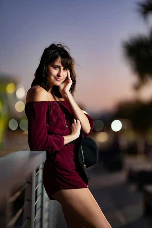 woman posing in the dark with long hair on a balcony