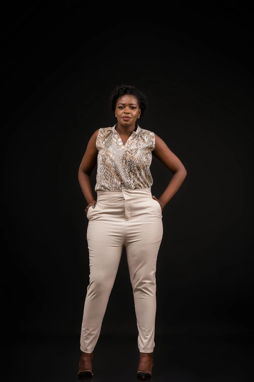 a woman in beige pants with a black background