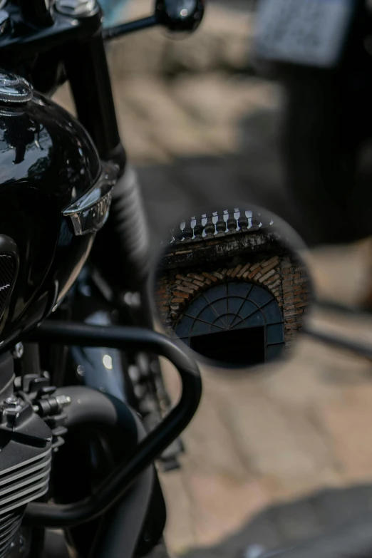 a close up of a motorcycle on a brick ground