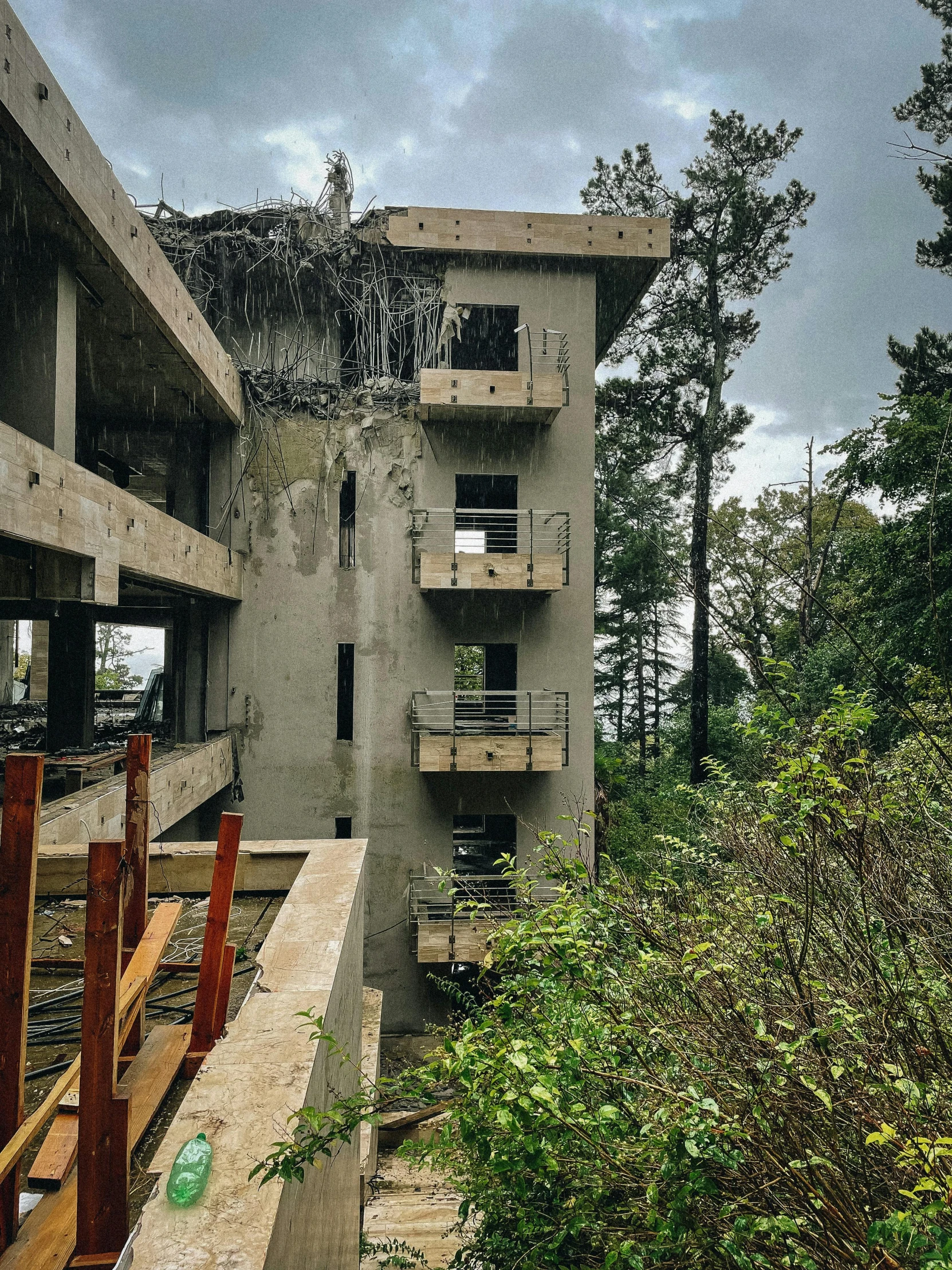 a dilapidated building with broken windows on an overcast day