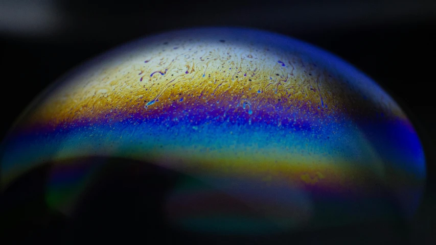 a close up s of a colorful sphere on a black background