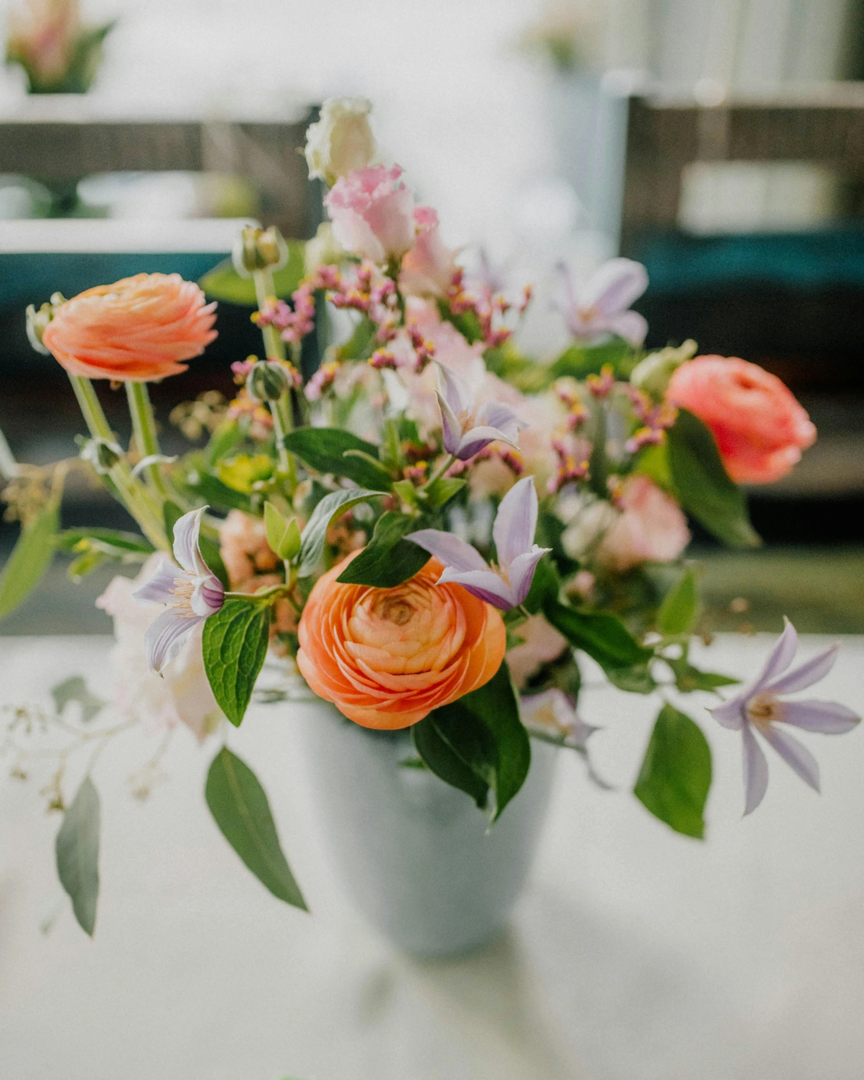 the vase is holding a variety of different flowers