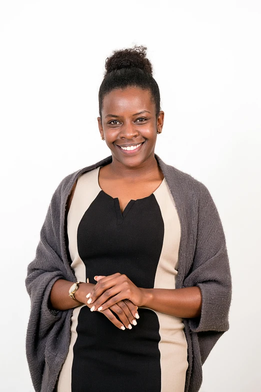 a woman in black dress standing with her arms crossed