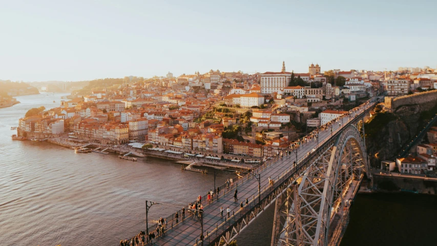 a bridge crossing over the water next to a large city