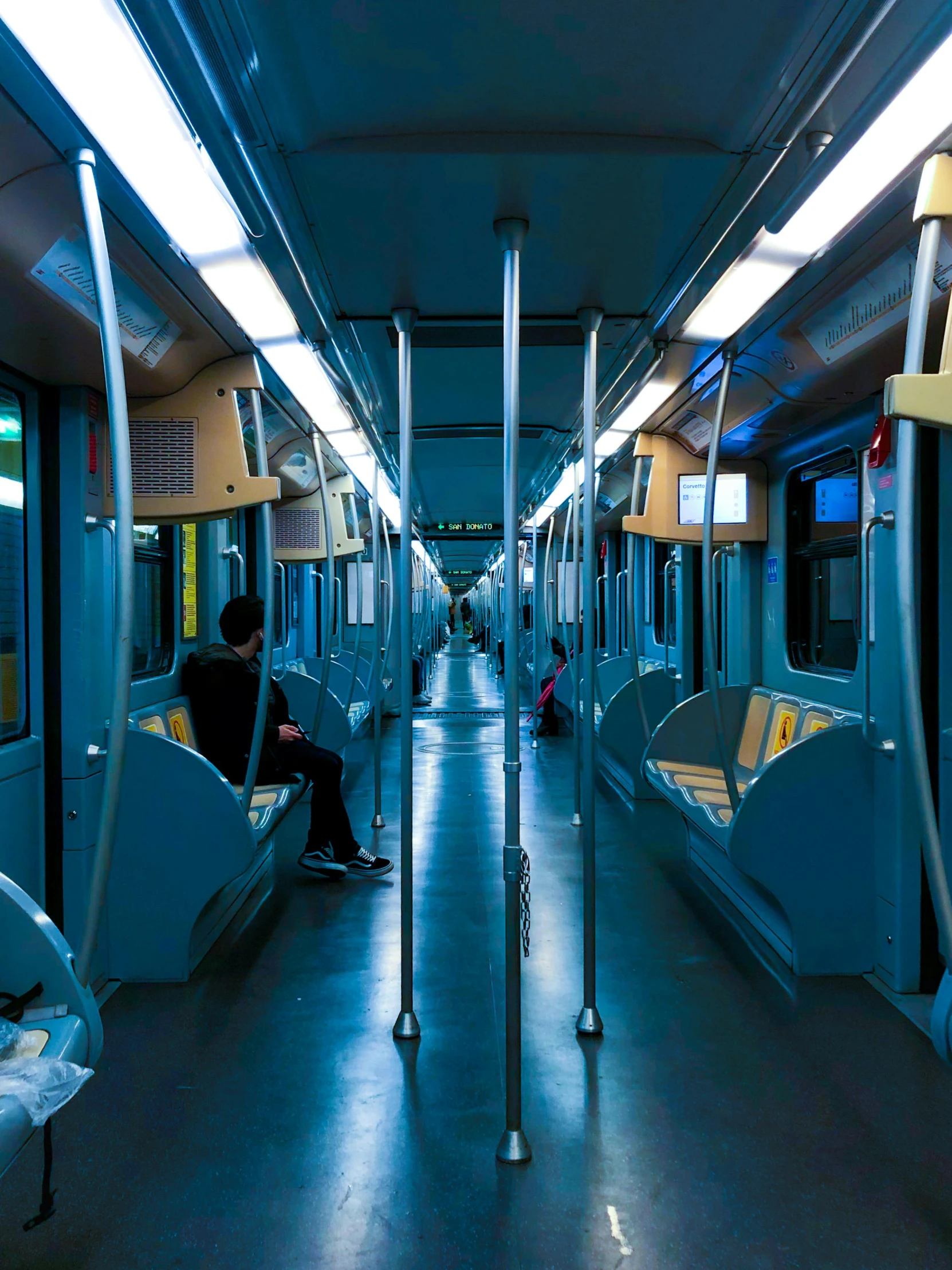 someone is sitting on a chair on a passenger train