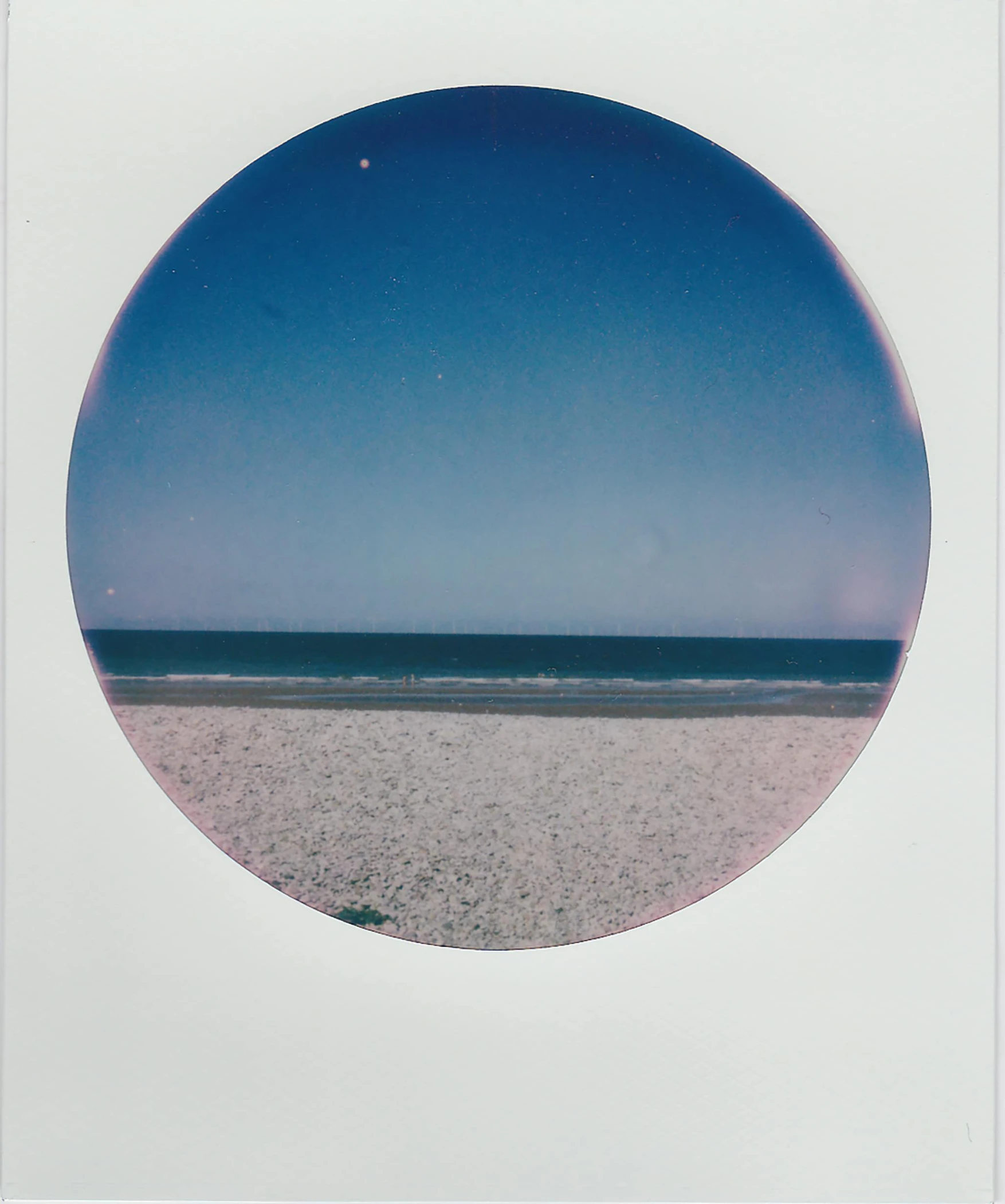 a circle shaped object sitting on top of a beach